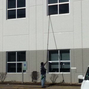 Photo of Powerhouse Pete washing a commercial building's windows