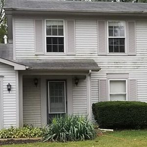 Before house washing photo of front of a white house