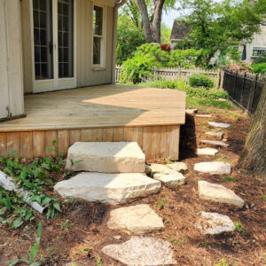 Photo of a wood deck and stone steps after being power washed