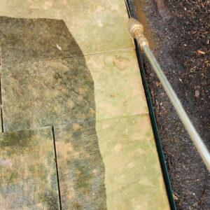Photo of concrete during power washing showing a comparison of dirty and clean